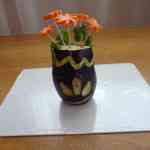 Ваза со цветами из баклажана и моркови